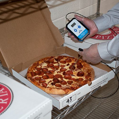 wireless food probe taking pizza temperature